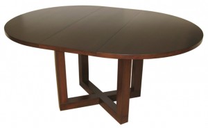 The Tangent Pedestal Table with leaf is one of our exclusive in-house designs. Built to order in BC, it is shown here with a 48” round top and 16” leaf in Maple wood and Java stain.